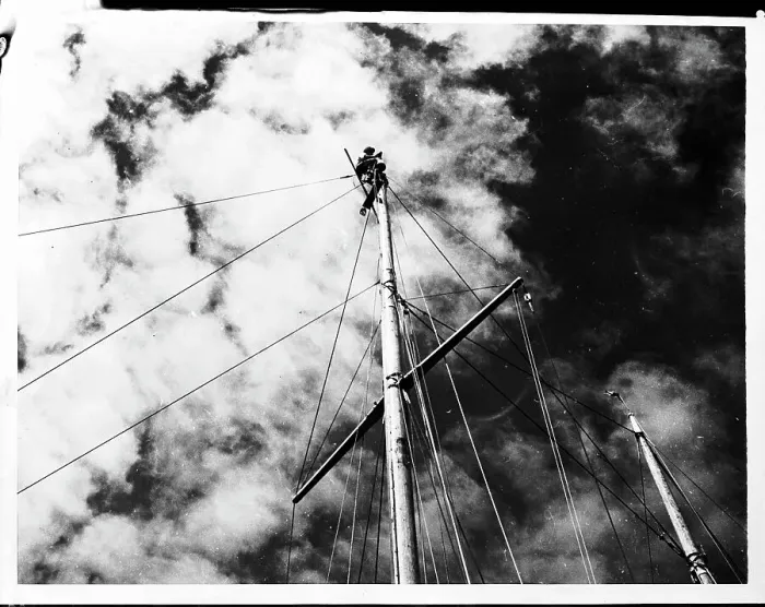 Framed Print : Man at Top of Ship's Mast Repairing a Light Framed Print : Man at Top of Ship's Mast Repairing a Light