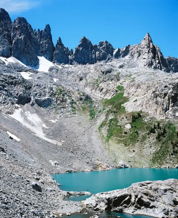 Framed Print : Man on shore of alpine lake with mountain peaks Framed Print : Man on shore of alpine lake with mountain peaks