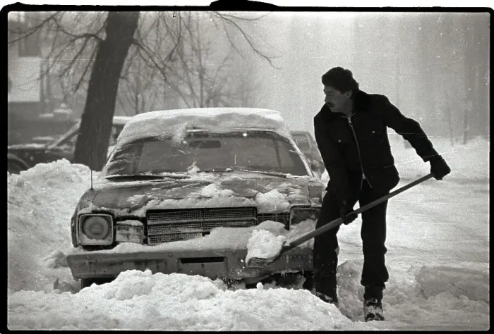 Framed Print : Man Shoveling out Car Framed Print : Man Shoveling out Car
