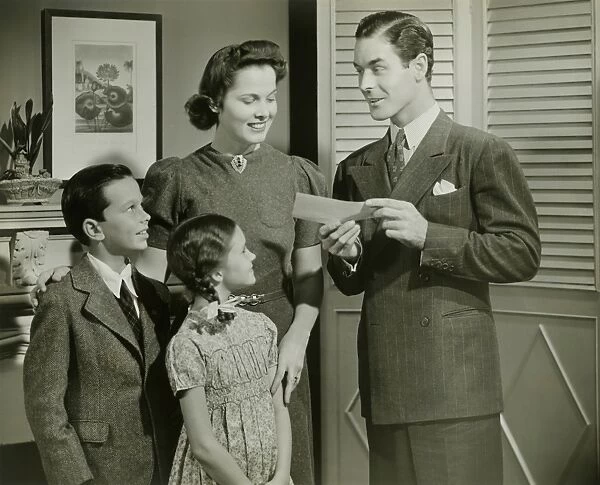 Man showing cheque or telegram to family