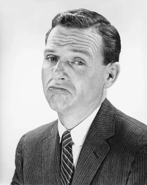 Framed Print : Man shrugging, posing in studio, (B&W), portrait Framed Print : Man shrugging, posing in studio, (B&W), portrait