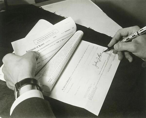 Man signing lease, close up of hands