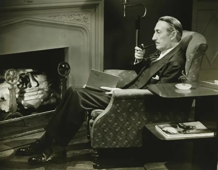Framed Print : Man sitting on armchair in front of fireplace, (B&W)