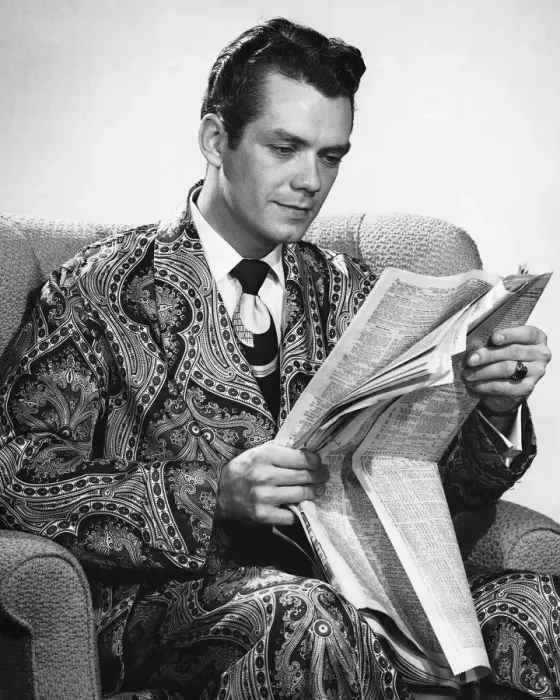 Framed Print : Man sitting in armchair, reading newspaper Framed Print : Man sitting in armchair, reading newspaper
