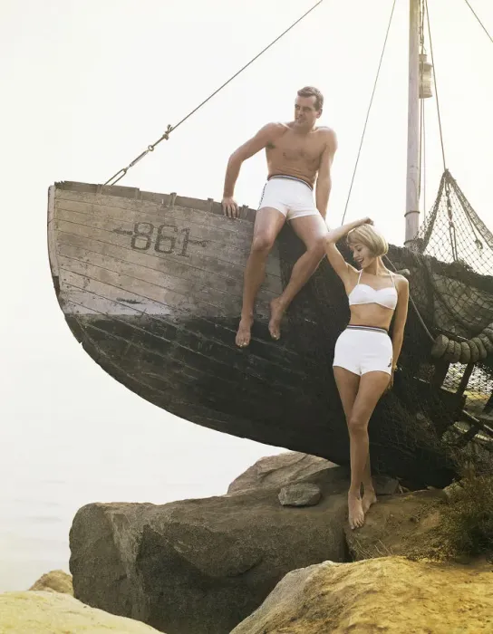 Framed Print : Man sitting boat, woman standing beside