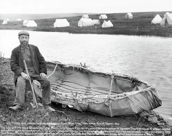 Framed Print : Man Sitting Next To Canvas Canoe Framed Print : Man Sitting Next To Canvas Canoe