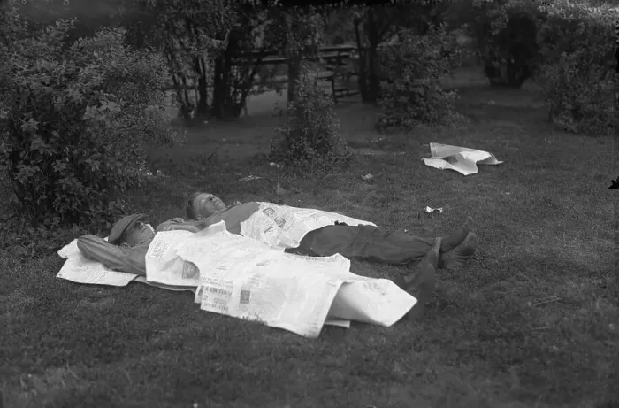 Framed Print : Two man sleeping in park covered with newspapers