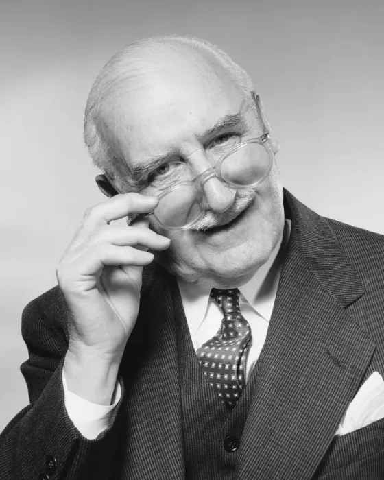 Framed Print : Man smiling, adjusting glasses Framed Print : Man smiling, adjusting glasses