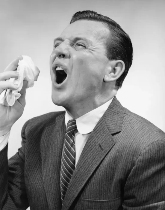 Framed Print : Man sneezing, posing in studio, (B&W), close-up Framed Print : Man sneezing, posing in studio, (B&W), close-up