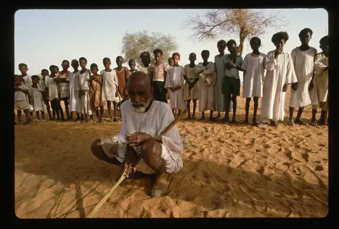Framed Print : Man Squatting in Front of Children