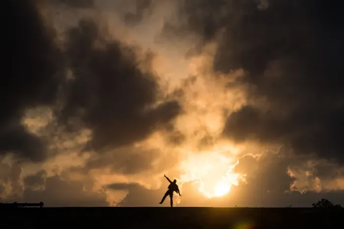 Framed Print : One man standing in causeway over cloudy sunset Framed Print : One man standing in causeway over cloudy sunset