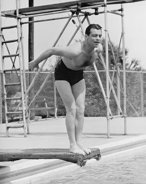 Man standing on diving board, preparing to dive (B&W)