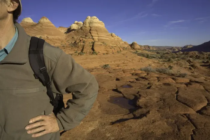 Framed Print : Man standing with hand on hip, sandstone buttes in background Framed Print : Man standing with hand on hip, sandstone buttes in background