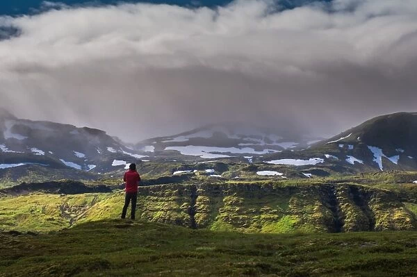 a man standing in front of iceland mountain landscape