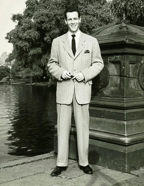 Man standing by lake in park, (B&W), (Portrait)