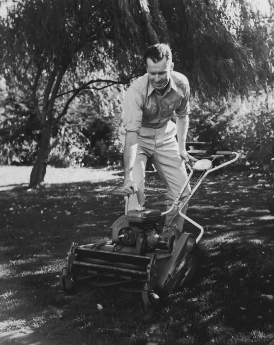 Framed Print : Man starting lawn mower (B&W) Framed Print : Man starting lawn mower (B&W)