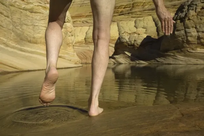 Framed Print : Man stepping into pool of water in sandstone, low section Framed Print : Man stepping into pool of water in sandstone, low section