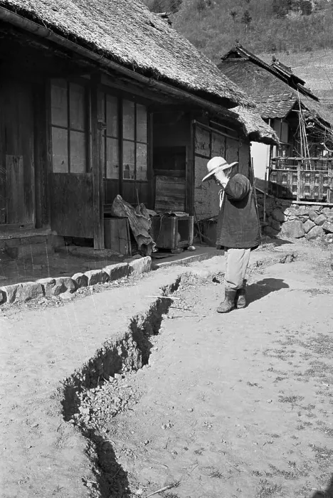 Framed Print : Man Studies Large Crack In Earth By Home Framed Print : Man Studies Large Crack In Earth By Home