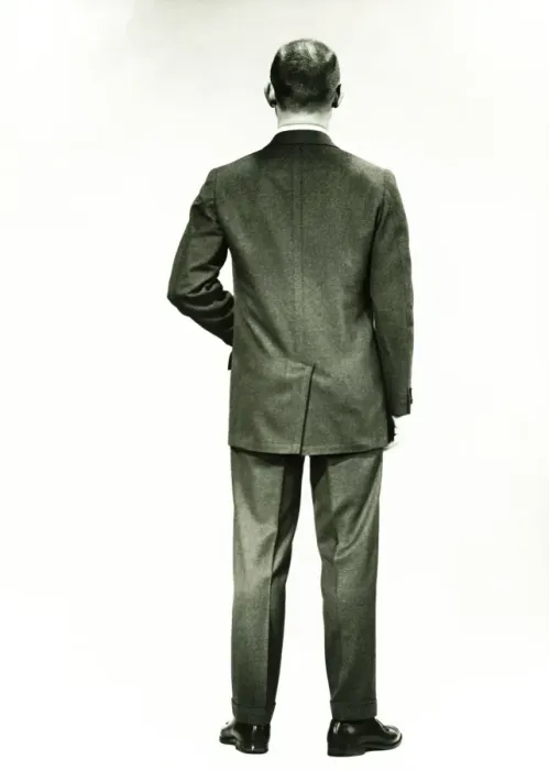 Framed Print : Man in full suit standing in studio, (Rear view), (B&W) Framed Print : Man in full suit standing in studio, (Rear view), (B&W)