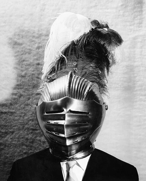 Man in suit wearing armour helmet with plumes, portrait