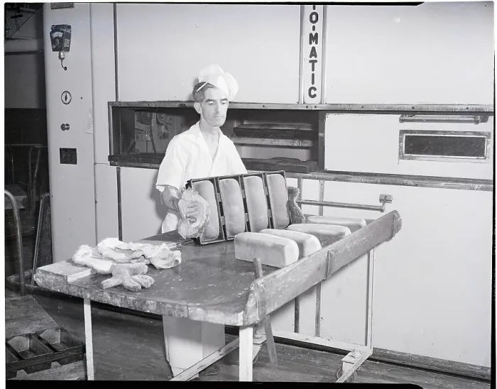 Framed Print : Man Taking Bread Loaves from Oven Framed Print : Man Taking Bread Loaves from Oven