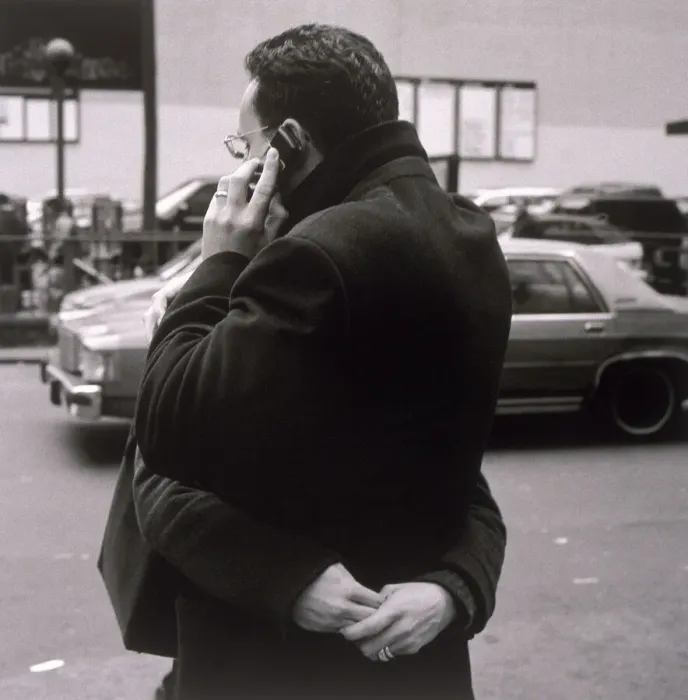 Framed Print : Man talking on cell phone and hugging woman Framed Print : Man talking on cell phone and hugging woman