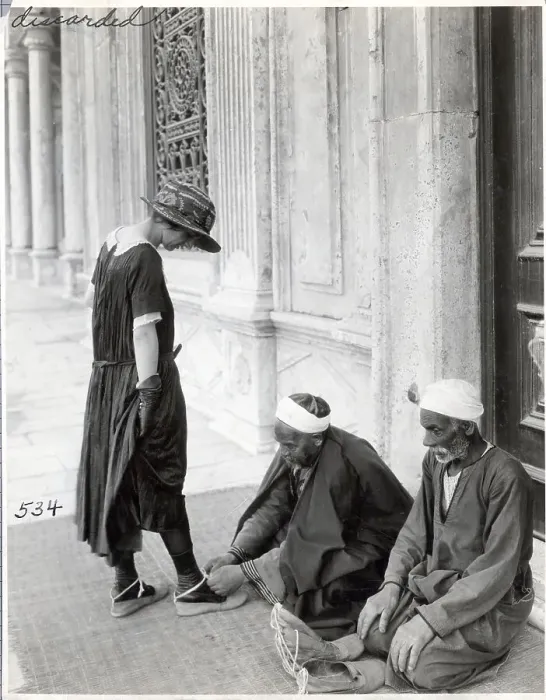 Framed Print : Man Ties Slippers on Tourist at Mosque