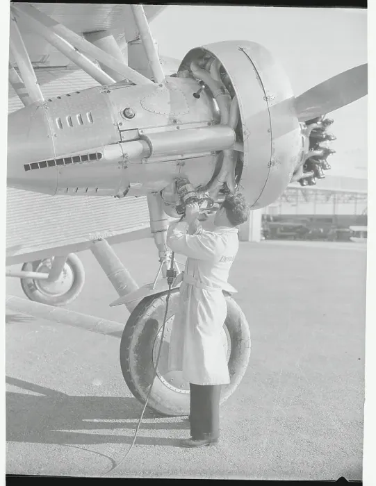 Framed Print : Man Using Portable Airplane Starting Device Framed Print : Man Using Portable Airplane Starting Device