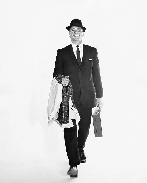 Man walking, carrying briefcase and jacket