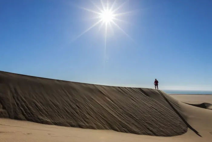 Framed Print : Man walking in the dune belt of Long Beach, Swakopmund, Namibia Framed Print : Man walking in the dune belt of Long Beach, Swakopmund, Namibia