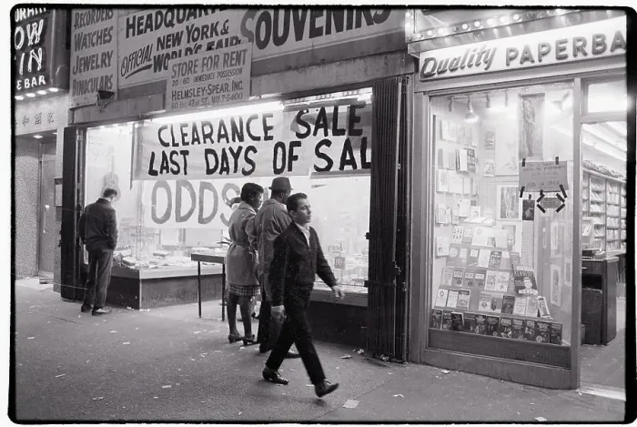 Framed Print : Man Walking Past Clearance Sale at Store Framed Print : Man Walking Past Clearance Sale at Store