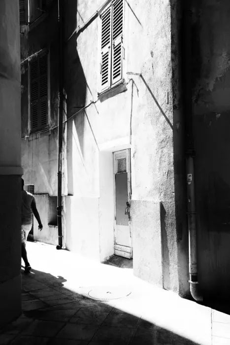 Framed Print : A man walking down a street in Old Nice, France Framed Print : A man walking down a street in Old Nice, France