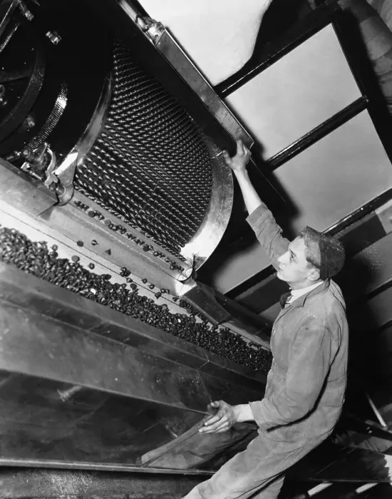 Framed Print : Man Watches Machine Making Hershey's Kisses in Factory