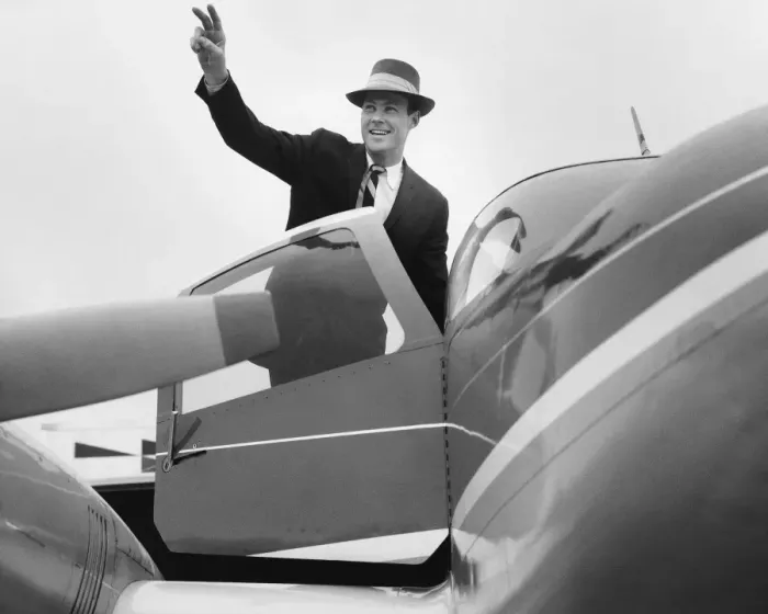 Framed Print : Man waving, getting in plane Framed Print : Man waving, getting in plane