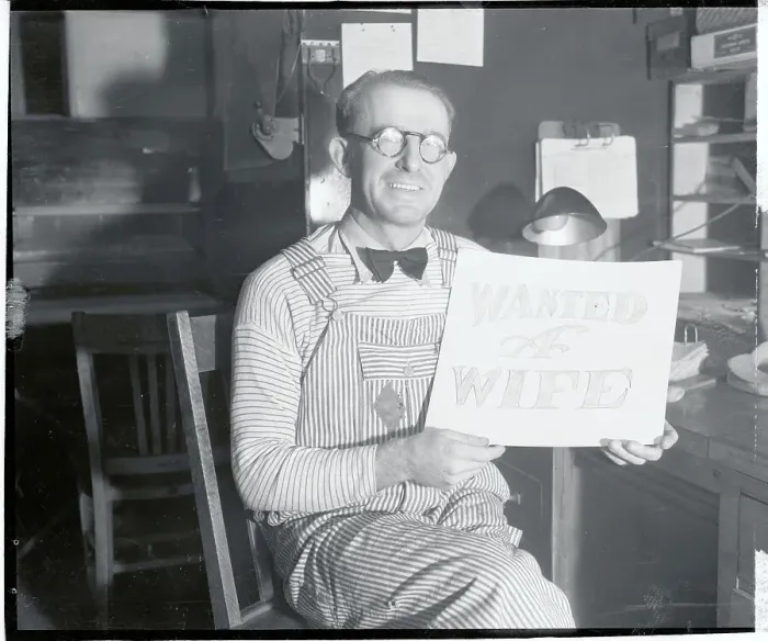 Framed Print : Man Wearing Overalls Holding Sign Asking for a Wife Framed Print : Man Wearing Overalls Holding Sign Asking for a Wife