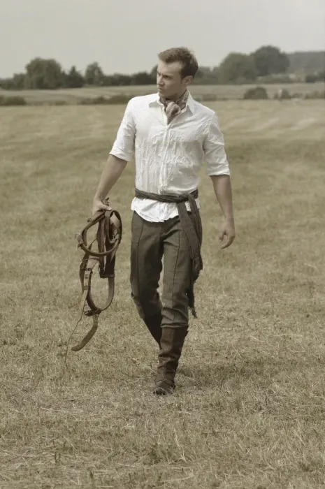 Framed Print : Man wearing riding clothes walking in a field in summer Framed Print : Man wearing riding clothes walking in a field in summer
