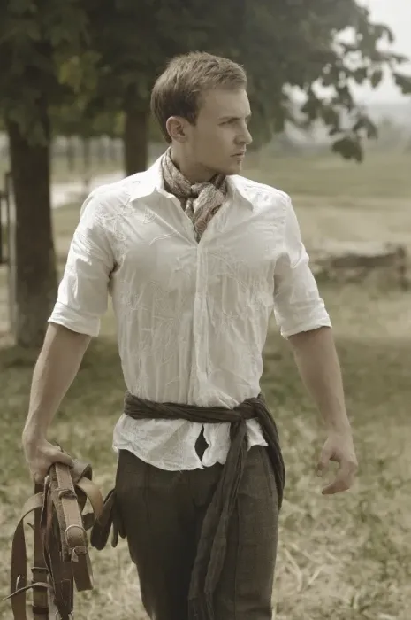 Framed Print : Man wearing riding clothes walking in a field in summer