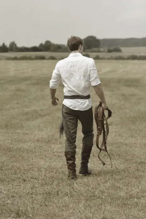Framed Print : Man wearing riding clothes walking in a field in summer Framed Print : Man wearing riding clothes walking in a field in summer
