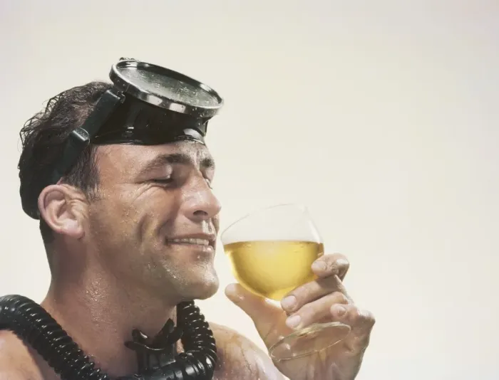 Framed Print : Man wearing snorkel holding wine glass, smiling Framed Print : Man wearing snorkel holding wine glass, smiling