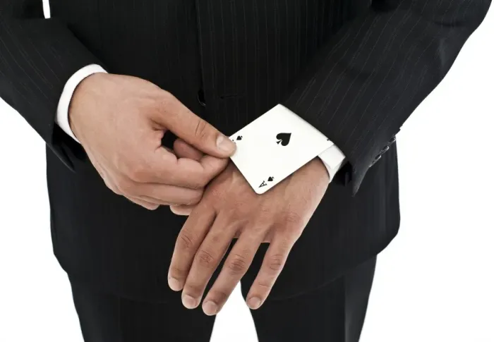 Framed Print : Man wearing a suit pulling an ace of spades out of his sleeve