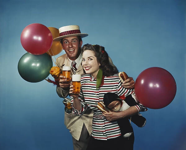 Man and woman with balloons and refreshments
