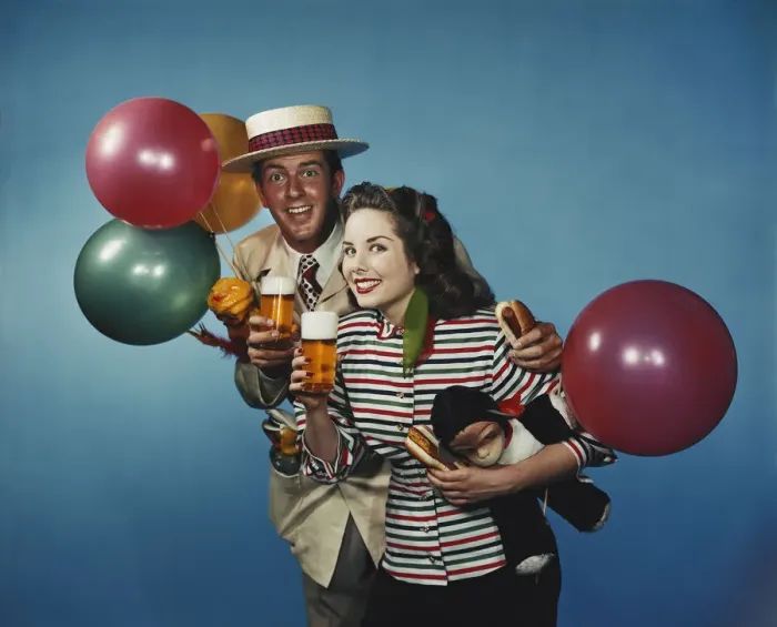 Framed Print : Man and woman with balloons and refreshments Framed Print : Man and woman with balloons and refreshments