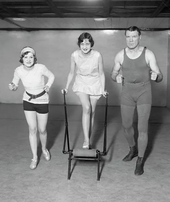 Framed Print : Man, Woman Run Alongside Woman On Machine Framed Print : Man, Woman Run Alongside Woman On Machine