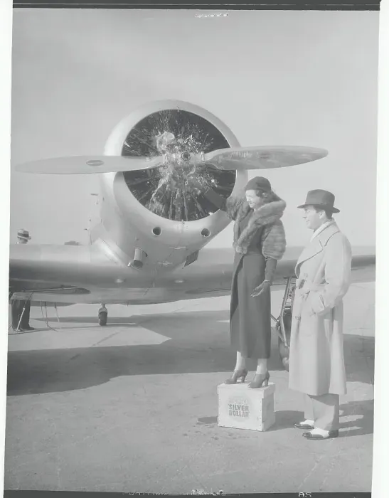 Framed Print : Man and Woman Standing Near Airplane