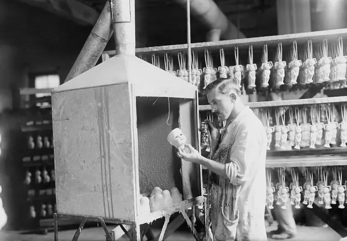 Framed Print : Man Working in Doll Factory Framed Print : Man Working in Doll Factory