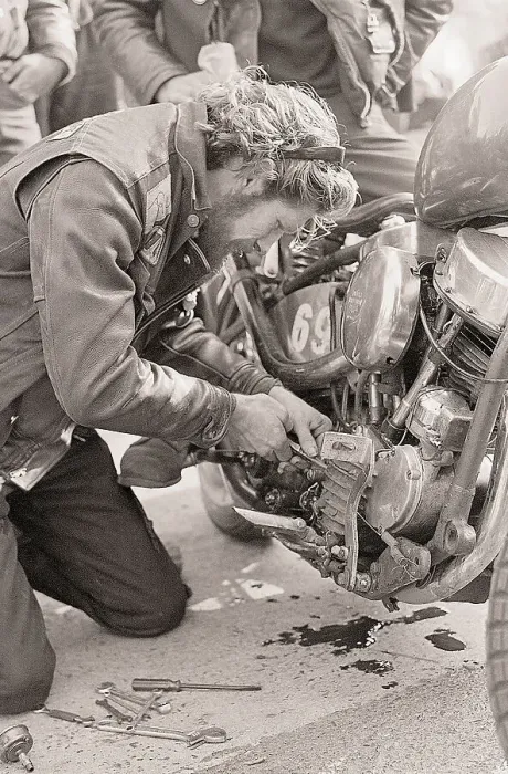 Framed Print : Man Works on Oil Gauge on Motorcycle Framed Print : Man Works on Oil Gauge on Motorcycle