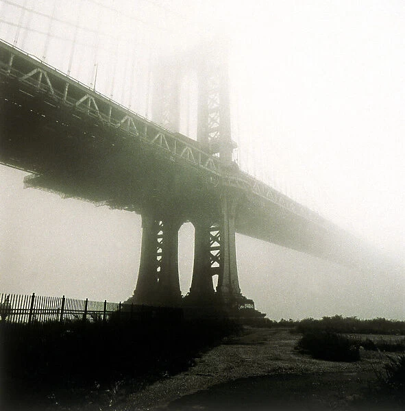 Manhattan bridge in mist in New York City, NY