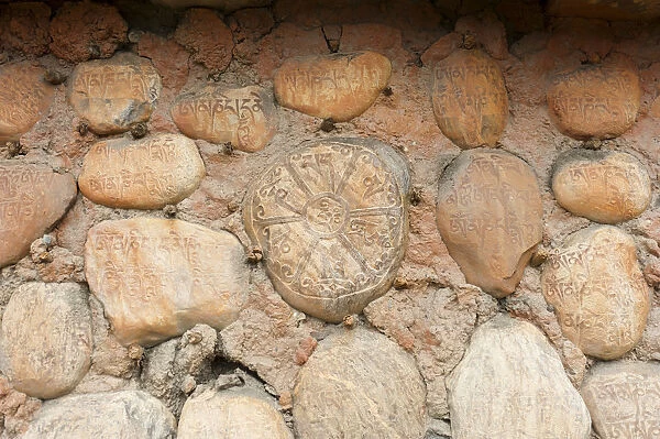 Mani stones with Tibetan inscriptions on wall, Buddhist Mani wall at Ghami, Upper Mustang, Nepal, Asia