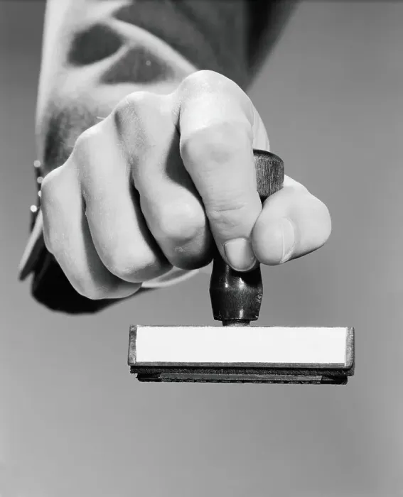Framed Print : Man's hand holding rubber stamp, poised about to stamp Framed Print : Man's hand holding rubber stamp, poised about to stamp