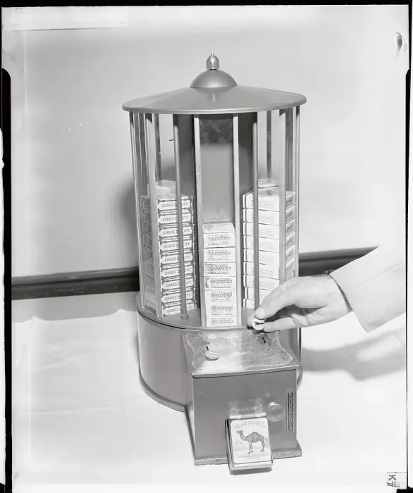 Framed Print : Man's Hand Holding Slug in Front of Cigarette Machine Framed Print : Man's Hand Holding Slug in Front of Cigarette Machine
